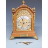 Goldsmiths Company of London Edwardian oak cased mantel clock with brass figural and floral