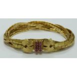 An 18ct gold bracelet made up of flat textured links set with rubies to the clasp, 49.5g