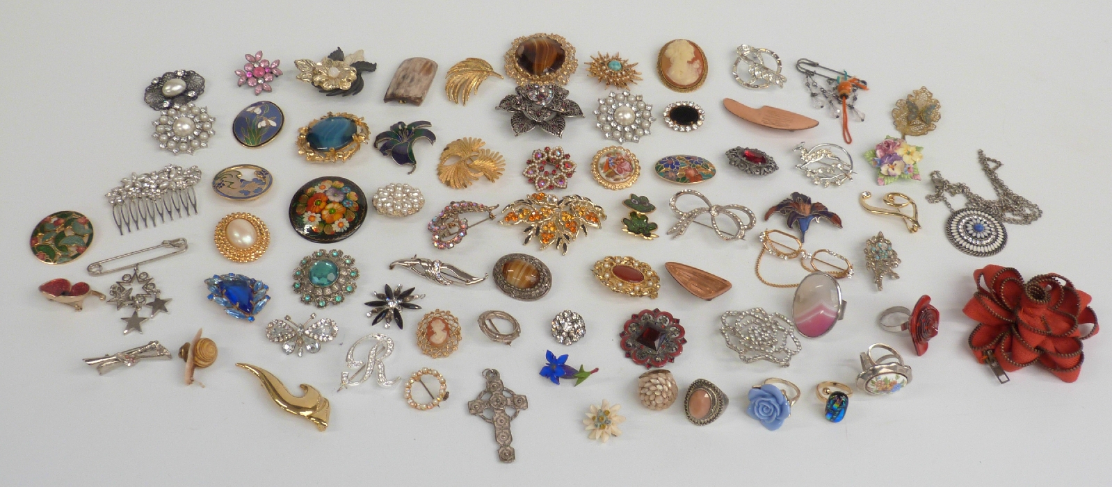 A collection of brooches including a DWH Scotland brooch, enamel brooches, Sarah Coventry brooch