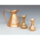 A trio of copper jugs, largest 30cm tall
