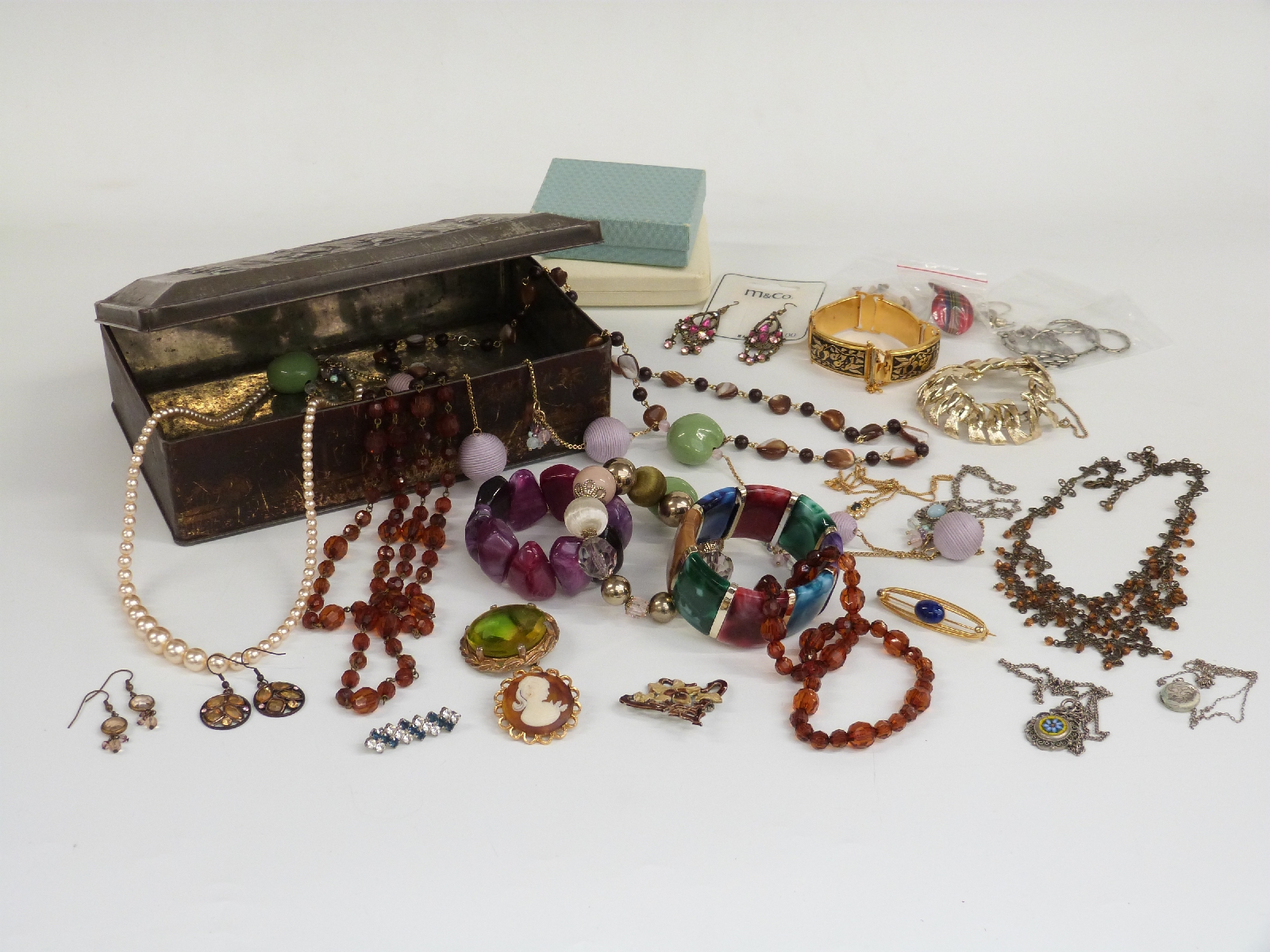 A collection of jewellery including beads, necklaces, Art Nouveau brooch, silver locket, micro