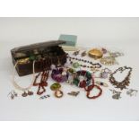A collection of jewellery including beads, necklaces, Art Nouveau brooch, silver locket, micro