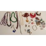 A collection of beaded necklaces including agate, garnet, a malachite pendant, silver beads, pearls,