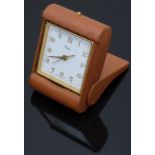 Asprey gold plated travelling alarm clock with gold and luminous hands, Arabic numerals, white