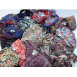 Approximately 11 vintage Liberty floral print dresses, similar skirt and a purple jacket