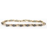 A 9ct gold tennis bracelet set with sapphires and diamonds, 6.6g