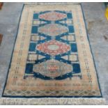 Small rug with blue and cream ground