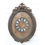 French vineyard clock in carved decorated case, with Roman cabochon numerals, pierced brass hands