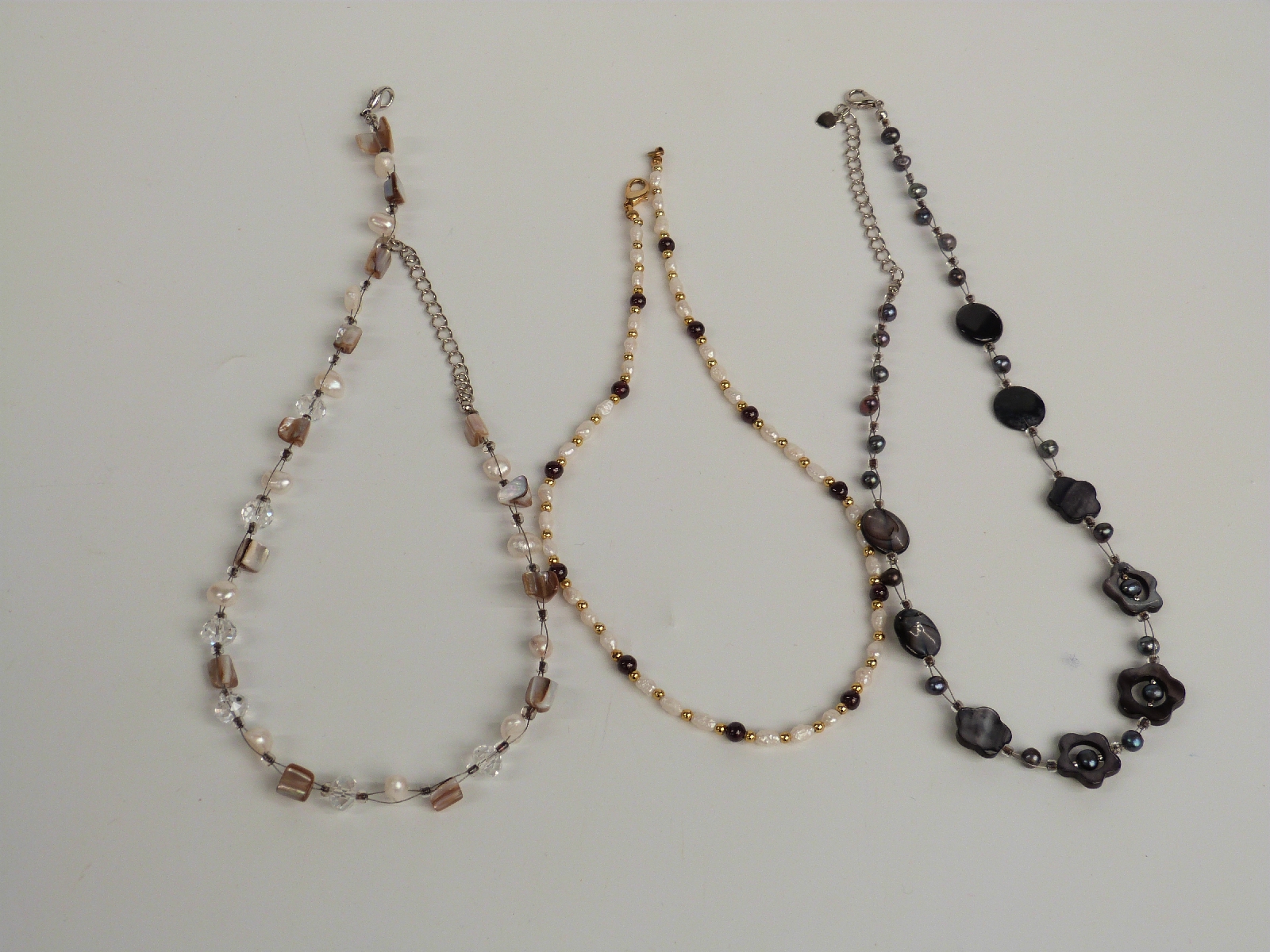 A collection of costume jewellery including necklaces, pearl and garnet necklace, watches etc in a - Image 4 of 6