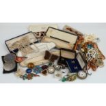A collection of costume jewellery including beads, brooches, watches, silver handled button hook,