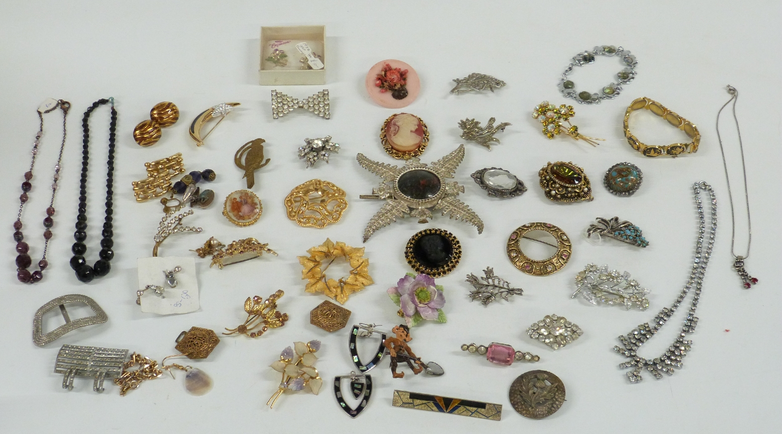 A collection of brooches including paste, Exquisite and Trifari, diamanté necklace, large thistle