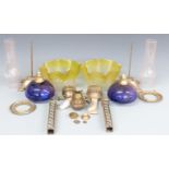 Two oil lamps in pieces with etched yellow glass shades and blue glass bowls
