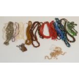 A collection of beaded necklaces including pearls, tiger's eye, glass, shell, coral etc