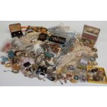 A large collection of costume jewellery including brooches, beads, bracelets, cufflinks, chains,