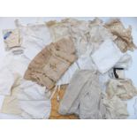 A collection of 19thC childrens and small sized clothing including blouses / shirts, corsets,