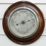 A circular mahogany aneroid barometer