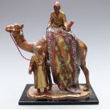 Bergman style cold painted table lighter formed as a carpet seller on a camel, height 18.5cm