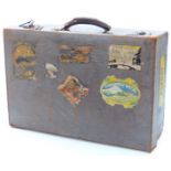 1930s suitcase with pale blue embossed lizard skin decoration and original travellers' labels