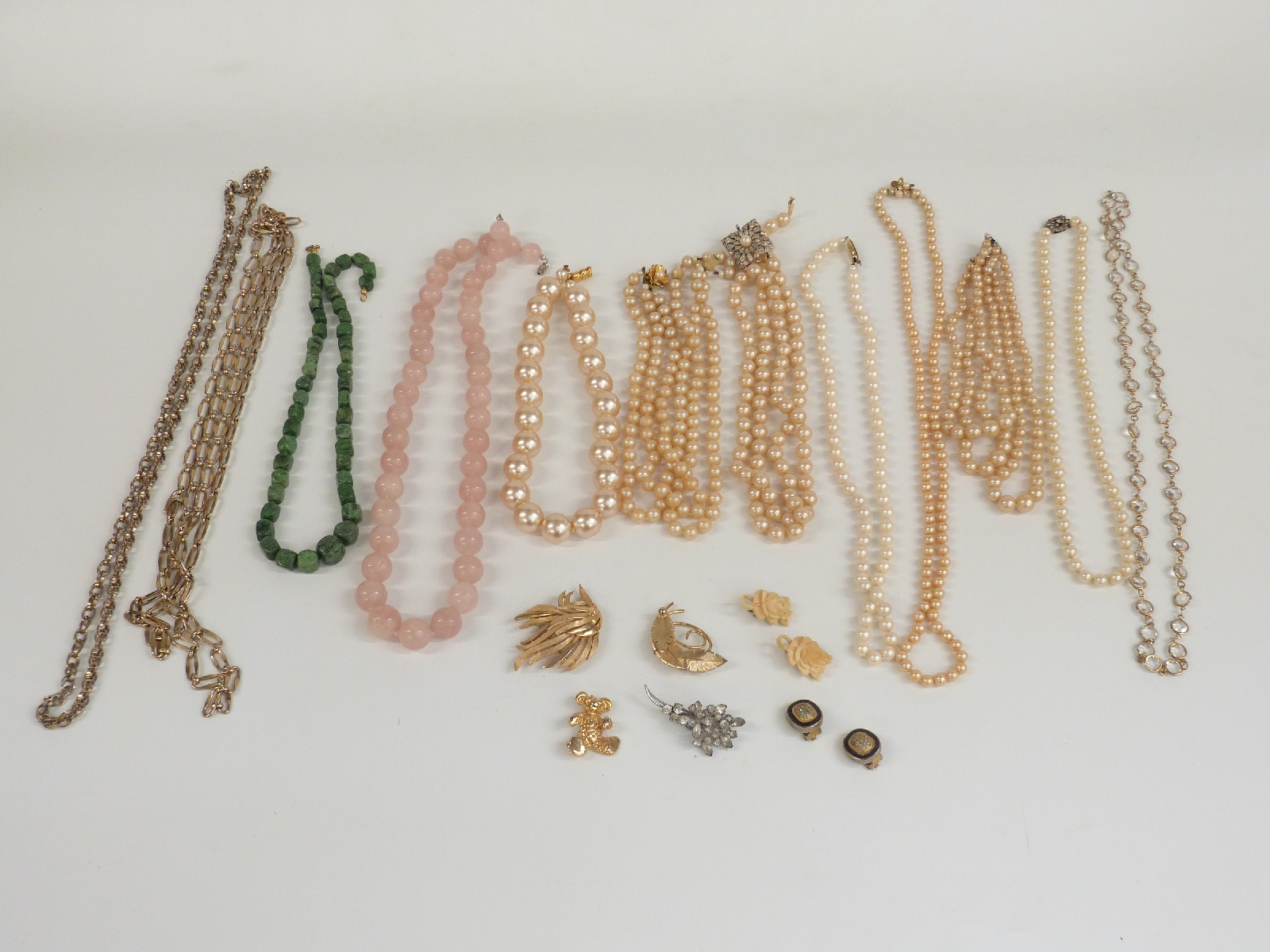 A collection of jewellery including rose quartz necklace, faux pearl necklaces one with a French