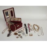A collection of costume jewellery including brooches, necklaces, Emporio Armani watch, silver curb
