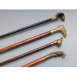 Four walking canes with novelty handles including parrot, snake and eagle