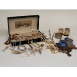 A collection of costume jewellery to include paste necklaces, brooches, coins etc