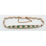 A rose gold Edwardian bracelet set with emeralds and diamonds, largest emerald 0.4ct, largest