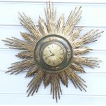 A retro 1960/70s sunburst clock, brass Roman dial with central engine turned decoration, 42cm