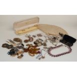A collection of costume jewellery including brooches, filigree brooch, glasses, pocket watch face,