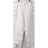 A pair of 19thC canvas breeches / trousers with engraved brass buttons