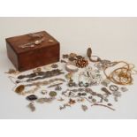 A collection of costume jewellery including a white metal bangle, mother of pearl pig charm, Art