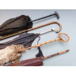 Five Edwardian parasols including lace examples, one with carved parrot handle, Japanese etc