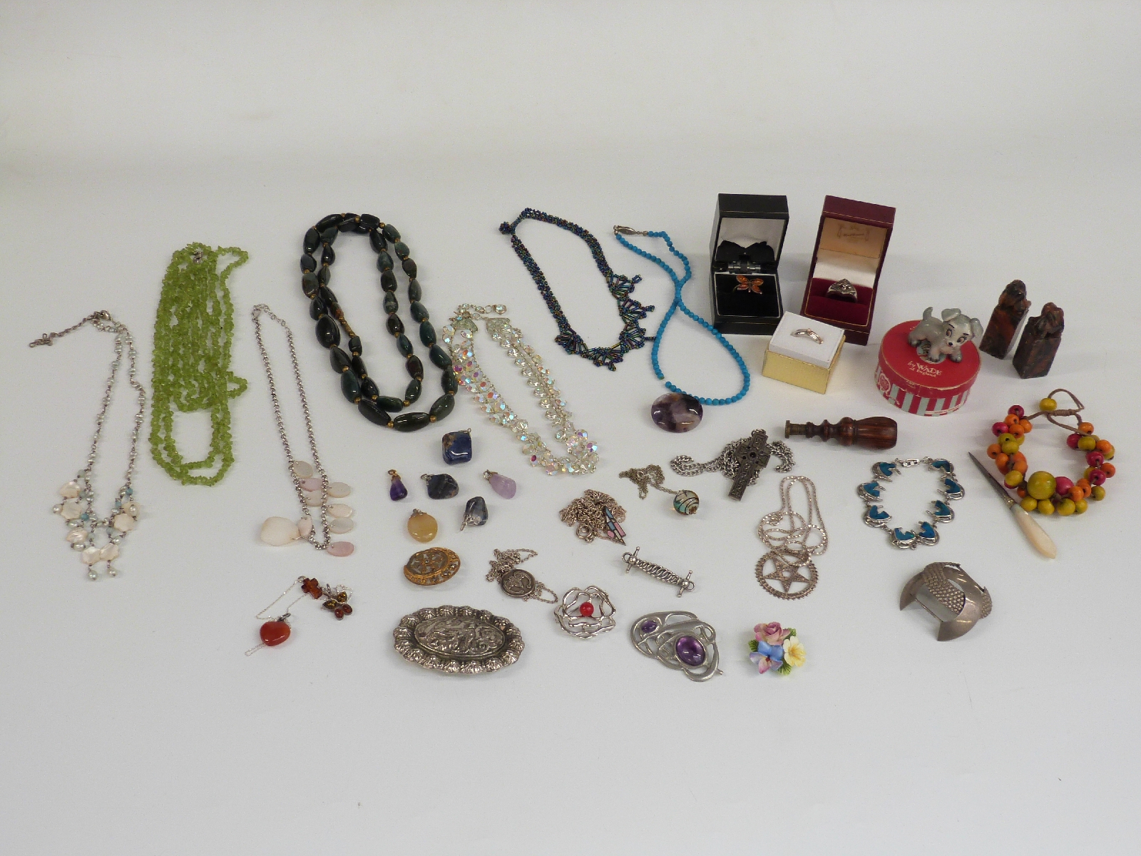 A collection of jewellery including silver pendants, amber and silver ring, agate brooch, silver