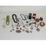 A collection of jewellery including silver pendants, amber and silver ring, agate brooch, silver