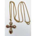 A 9ct gold necklace and a 9ct gold cross set with garnets, 4.3g