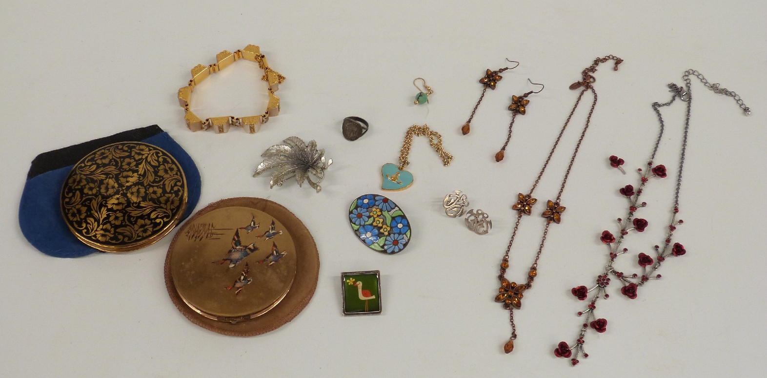 A collection of costume jewellery including a silver and enamel brooch, Exquisite brooch, silver