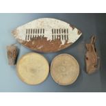 Two North African leather shields, Zulu style shield and a small drum, largest item 80cm