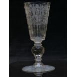 A large 19thC cut glass goblet with faceted and engraved bowl raised on multi-faceted and knopped