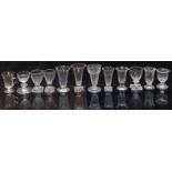 Twelve 19thC and later cut glass vases, some with knopped stems and some raised on square cut bases,