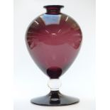 A large cranberry glass vase of bulbous form with clear knop, flared rim and conical foor, 38cm tall