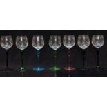 A set of six glass drinking glasses with engraved bowls and coloured stems and feet, 19.5cm tall