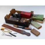 Collection of barber's shop related items including razors, strop, clippers, advertising ware etc