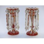 A pair of Victorian double overlaid cut glass lustres with gilt, pink and white decoration over a