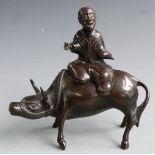 A 19thC Chinese bronze model of an ox and man, H16cm