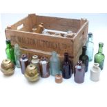 A collection of glass and stoneware bottles to include Nibletts and R Whites etc together with