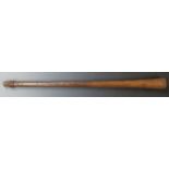 A 19thC Aboriginal war club of tapering form with carved ridged decoration along approximately