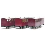 A rake of three 32mm gauge garden railway matchboard passenger coaches, one with guard's