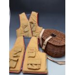 Two Stearns life preservers/fishing jackets and a wicker creel