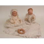 Two Armand Marseille bisque headed twin dolls both with weighted eyes, open mouths, jointed