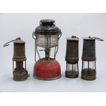Three vintage miners lamps and a Tilley lamp